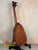 Wooden ukulele on black stand for Pepe Romero TTM-23032 Tiny Tenor Mahogany