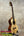 Wooden ukulele on stand from Phil Henderson showcasing the Ladder PCH Tenor Ukulele