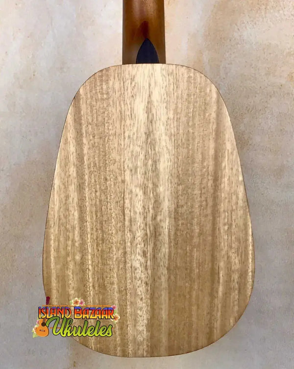 Wooden cutting board showcasing natural grain with Pono Mango Pineapple Ukulele MGTP Solid Wood