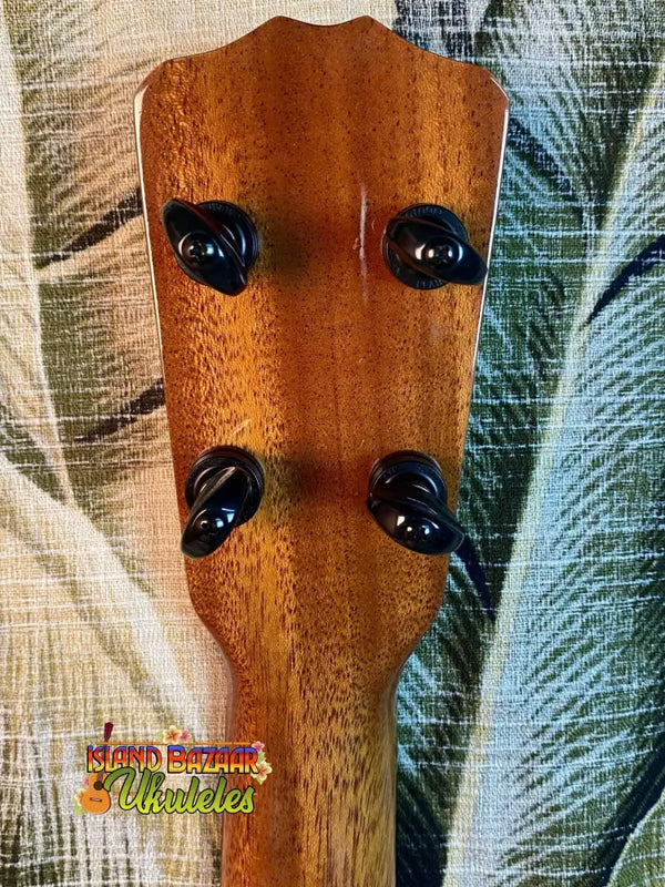 Wooden ukulele headstock with four black tuning pegs for Romero Creations Spalted Mango