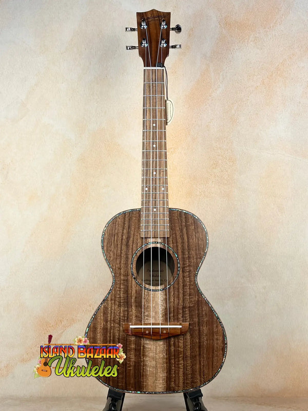 Wooden tenor acacia ukulele featuring dark grain patterns in Acacia Ukulele Beginners Bundle