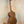 Wooden tenor acacia ukulele with grain patterns on a stand in a beginners bundle