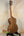 Wooden tenor acacia ukulele with grain patterns on a stand in a beginners bundle