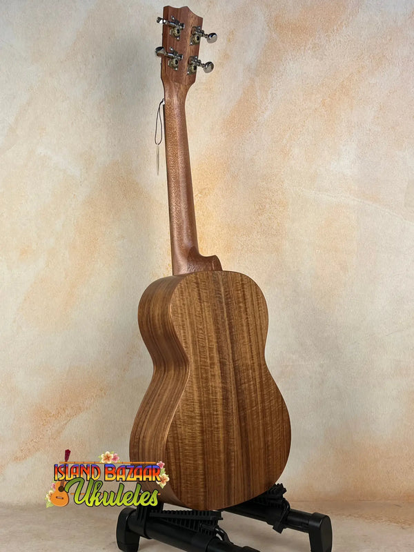 Wooden tenor acacia ukulele with grain patterns on a stand in a beginners bundle