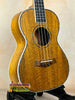 Beautiful wooden tenor mango ukulele with rich honey-colored grain in beginners bundle