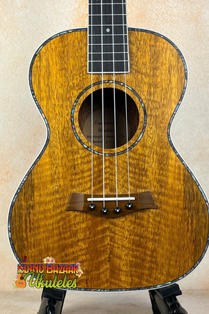 Beautiful Koa wood tenor ukulele with decorative inlays from the Tenor Mango Ukulele Beginners bundle