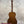 A polished mahogany vintage martin custom baritone ukulele with glossy finish and white tuning pegs on a stand