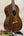 A polished dark brown vintage martin custom baritone ukulele with glossy finish and white binding edges with case