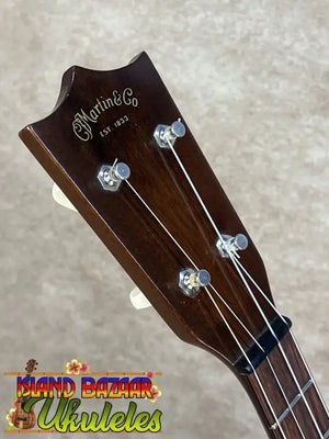 Dark brown wooden headstock of a vintage martin custom baritone ukulele from the late 1960s pre owned