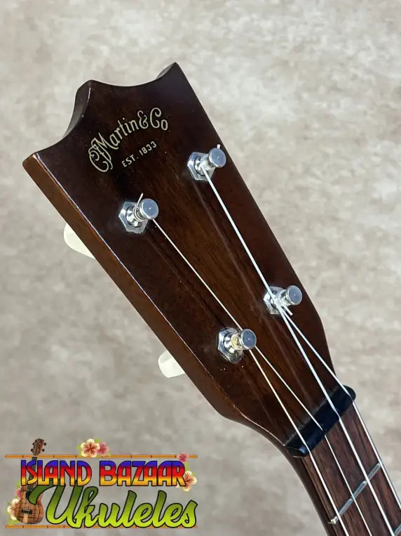 Dark brown wooden headstock of a vintage martin custom baritone ukulele from the late 1960s pre owned