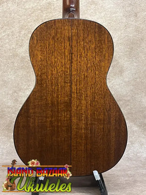 Back of a warm-toned vintage martin baritone ukulele with glossy wood grain finish custom late 1960s model