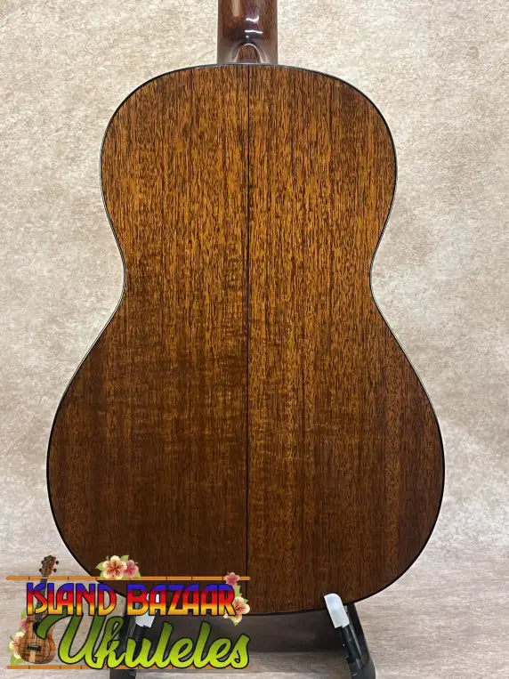 Back of a warm-toned vintage martin baritone ukulele with glossy wood grain finish custom late 1960s model
