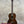 Vintage martin dark brown polished wooden custom baritone ukulele with white binding around the soundhole