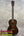 Vintage martin dark brown polished wooden custom baritone ukulele with white binding around the soundhole