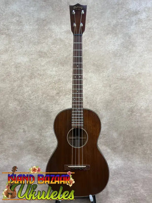Vintage martin dark brown polished wooden custom baritone ukulele with white binding around the soundhole