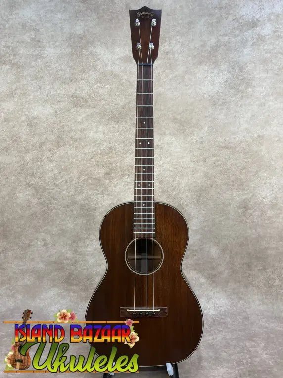 Vintage martin dark brown polished wooden custom baritone ukulele with white binding around the soundhole