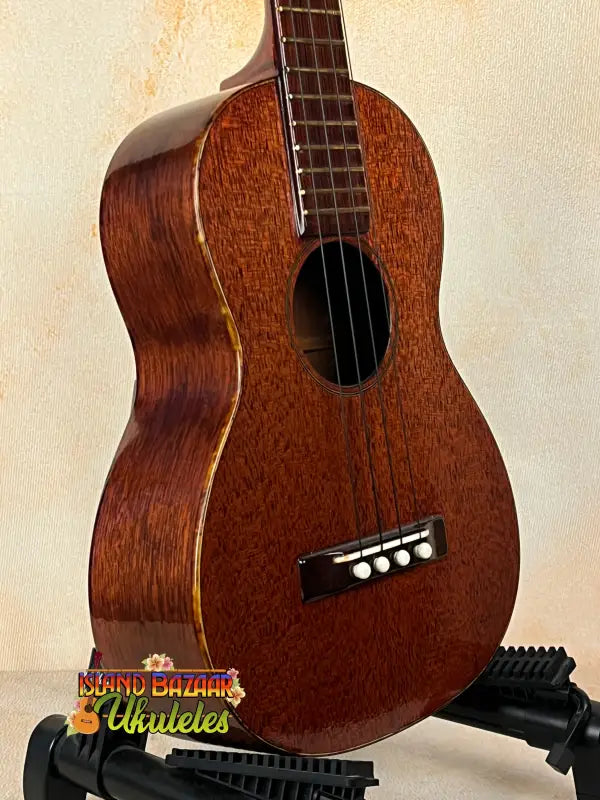 Brown wooden Vintage Martin Soprano Ukulele from the 1940s-50s, well-loved and modified