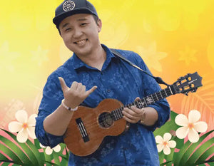 A wooden ukulele being held with a shaka hand gesture.